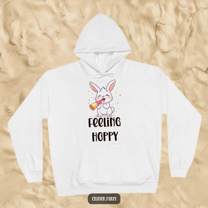 Funny giggling bunny blowing a party horn amidst flying confetti, cozy and humorous hoodie.