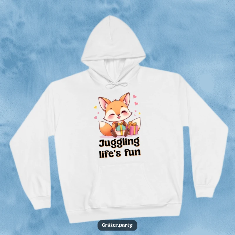 Funny fox juggling hoodie with a winking fox character juggling small, brightly colored gift boxes, offering cozy and witty style.