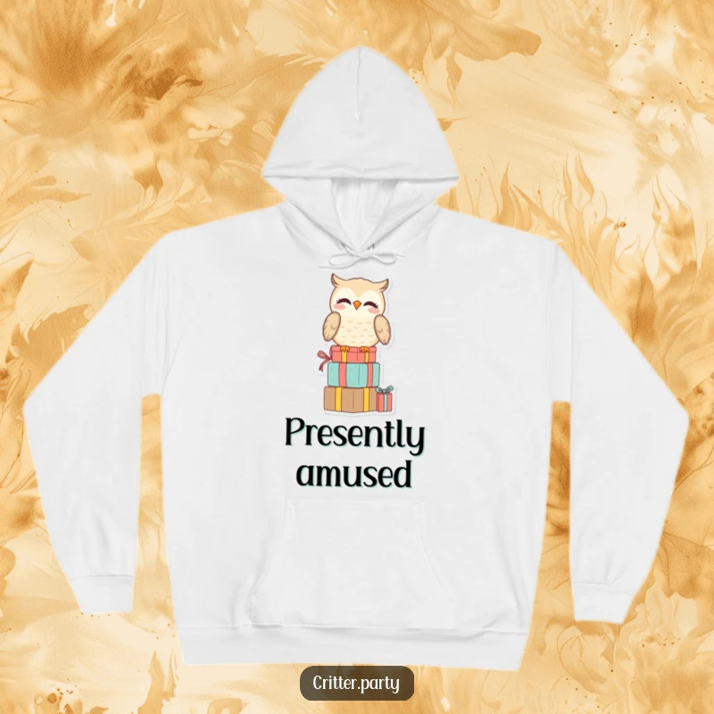 Funny hoodie featuring a smiling owl perched on a stack of presents, looking amused, offering cozy comfort and witty charm.