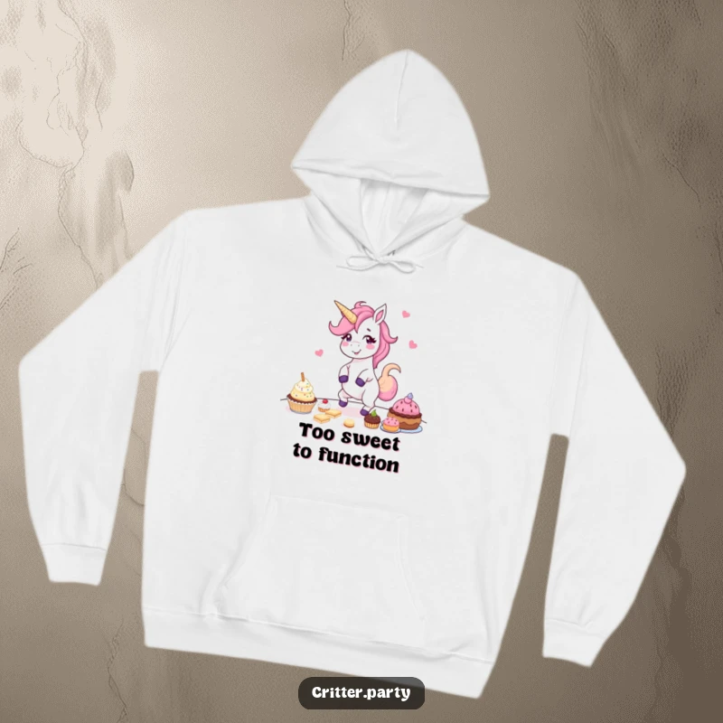 Funny hoodie featuring a giggling unicorn energetically dancing amidst a table laden with delightful party treats, embodying sheer exuberance.